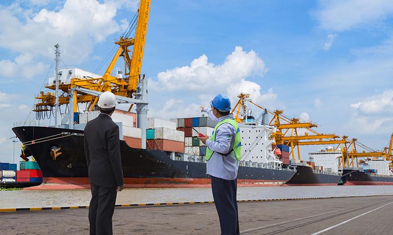 Shipping agency representative and port crew conducting vessel operations at a commercial port in Bangladesh